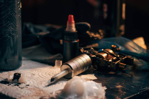 Tattoo equipment on a table, ready for sterilization before use, highlighting the importance of proper sterilization techniques in tattooing.