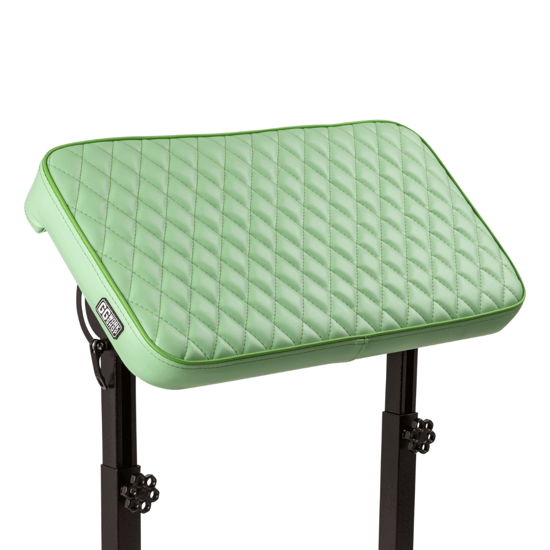 Green vinyl tattoo pillow for clients on adjustable armrest, ideal for customized tattoo sessions and arm comfort.